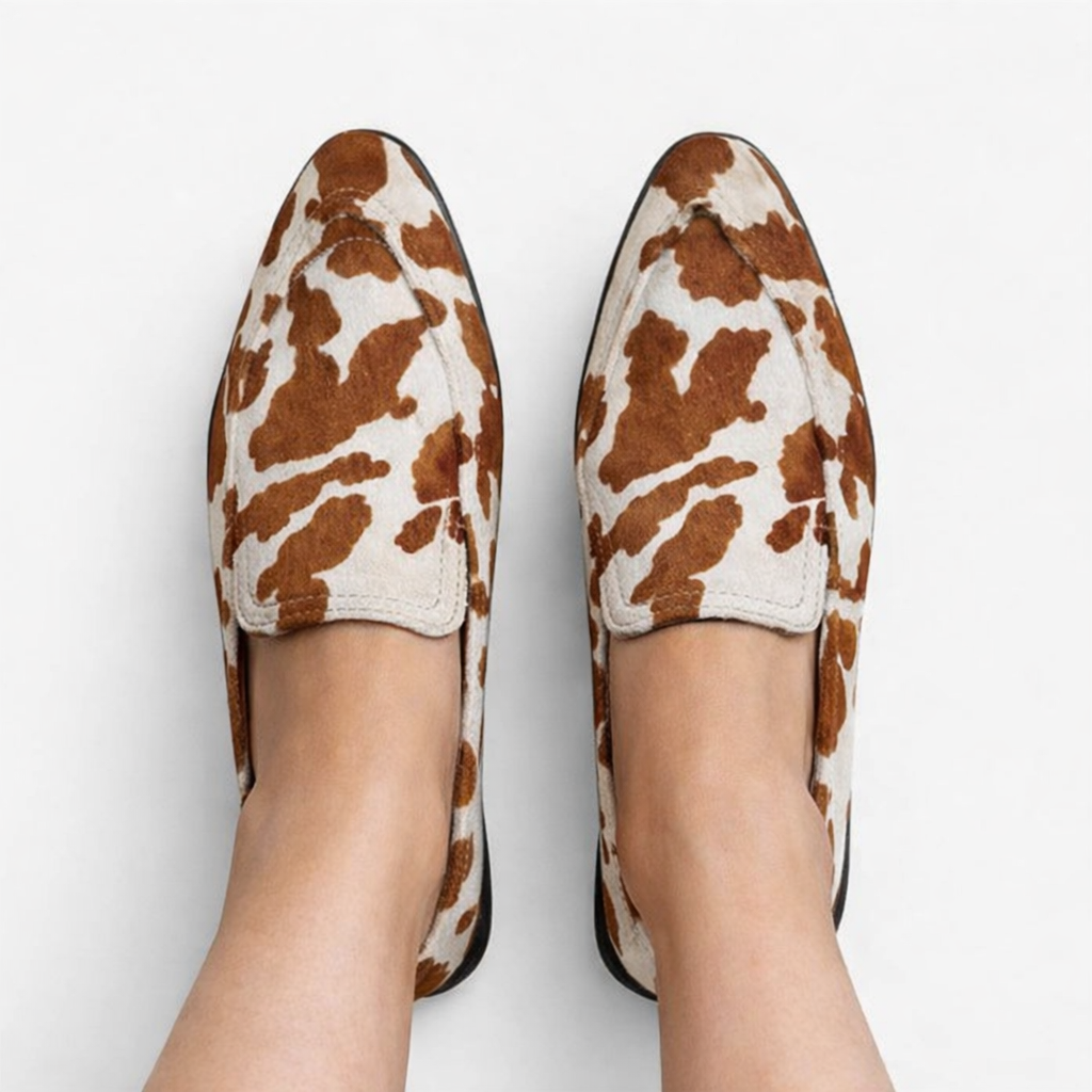 Sophia cow-print loafers in brown and cream, worn top view