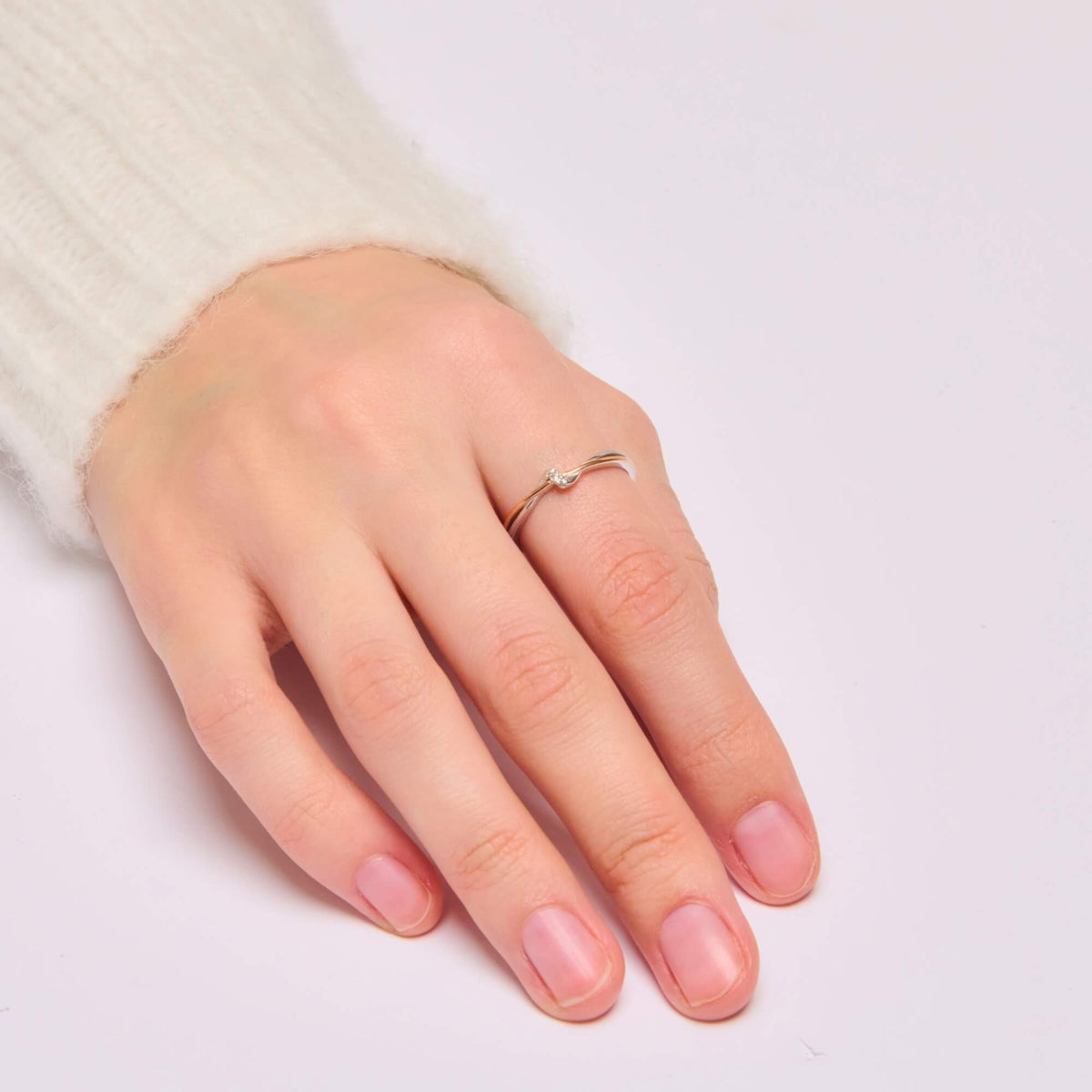 Adjustable two-tone eternity ring shown on a model's finger