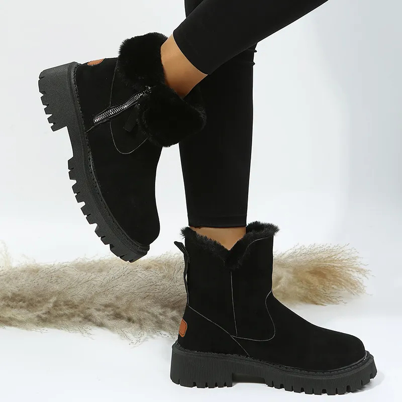 Noria winter boots in black with fur-look cuff, worn angled view