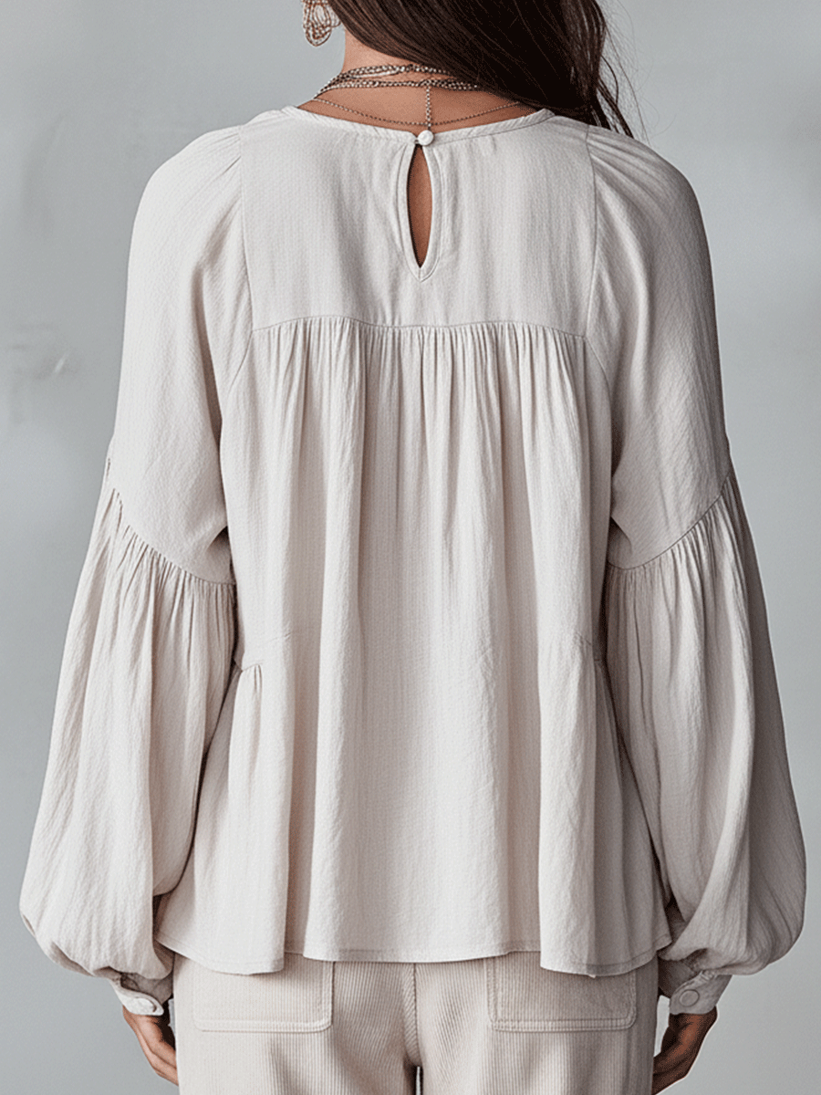 White bohemian blouse back view showing keyhole button opening