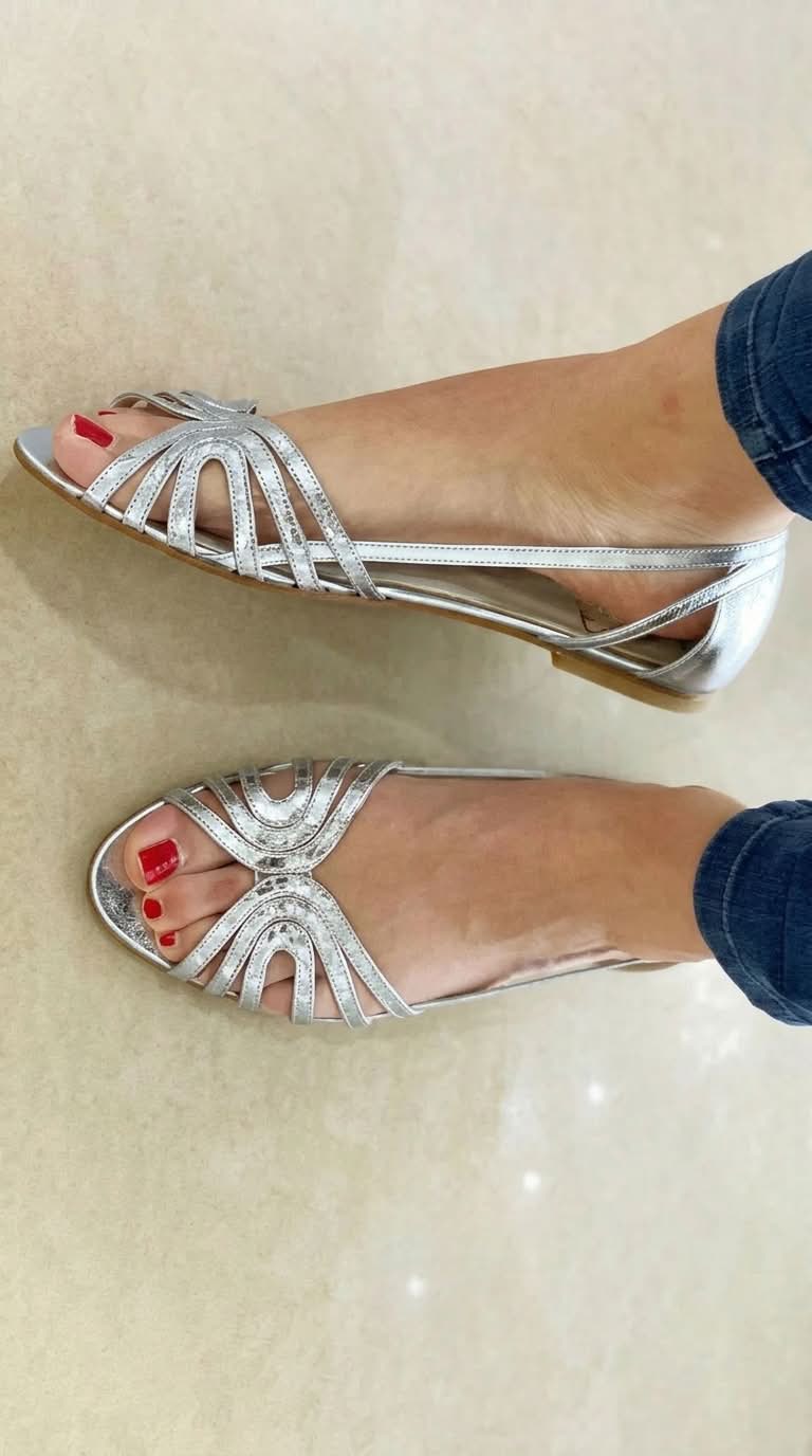 Eleonora flat sandals in silver, worn view showing looped straps