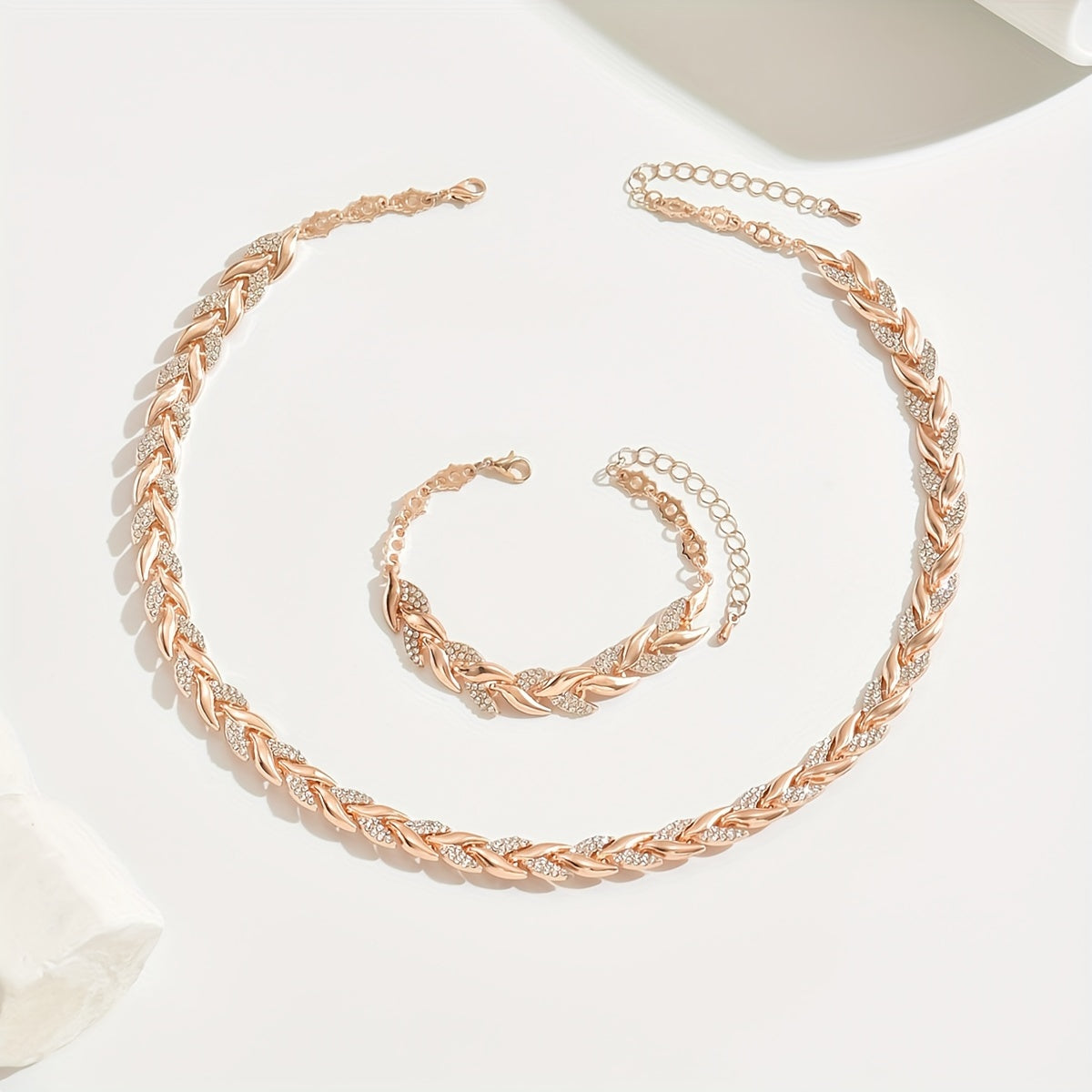 Rose gold necklace and bracelet laid flat showing clasp and extender chains