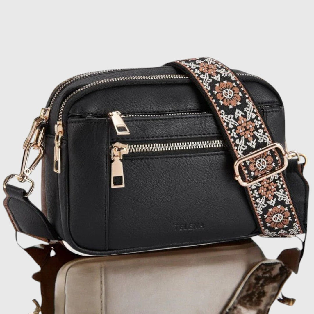 Dina shoulder bag in black with gold zips, front view