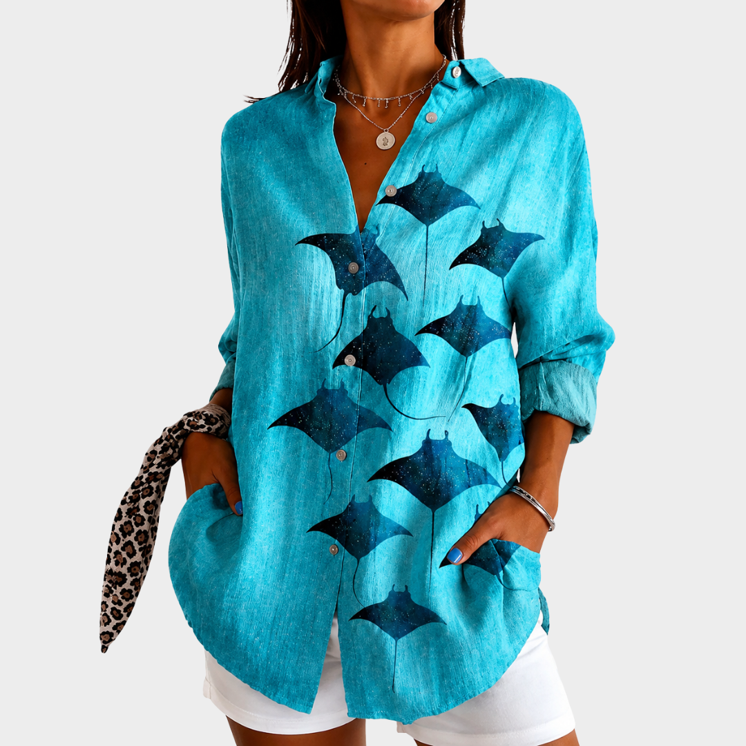Calm Waves blouse in turquoise with navy manta ray print, front view worn with white shorts