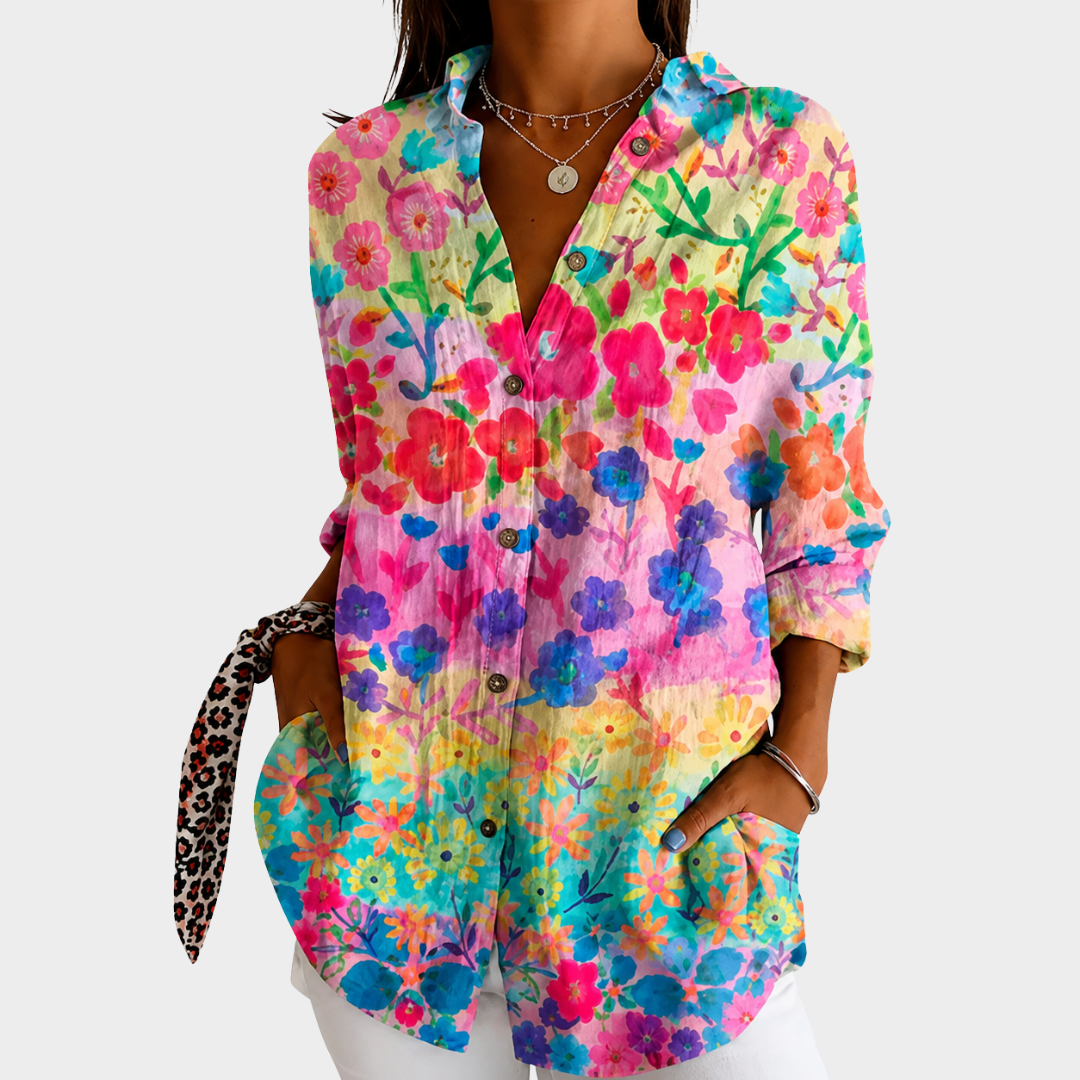 Pastel meadow floral blouse in multicoloured watercolour print, front view worn with white trousers