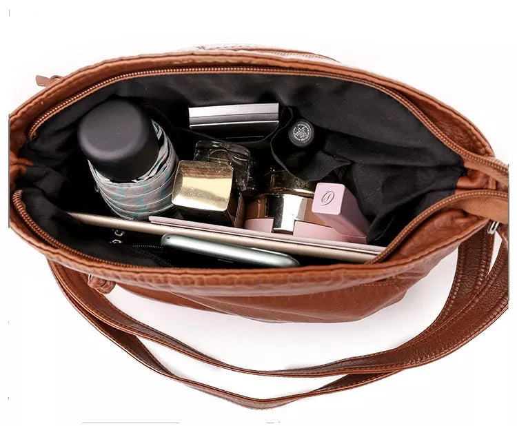 Celine shoulder bag interior in brown, micro-suede lining holding everyday essentials