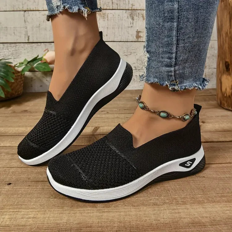 Azalea slip-on sneakers in black, worn side view