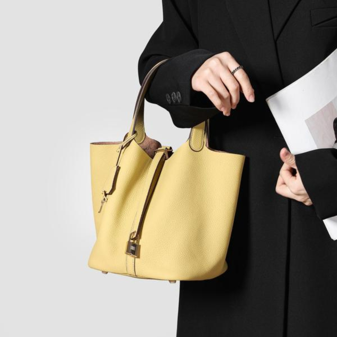 Kate lock bag in yellow, showing open top and lock charm