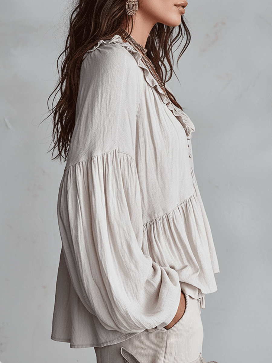 White bohemian blouse side view showing balloon sleeve and tiered hem