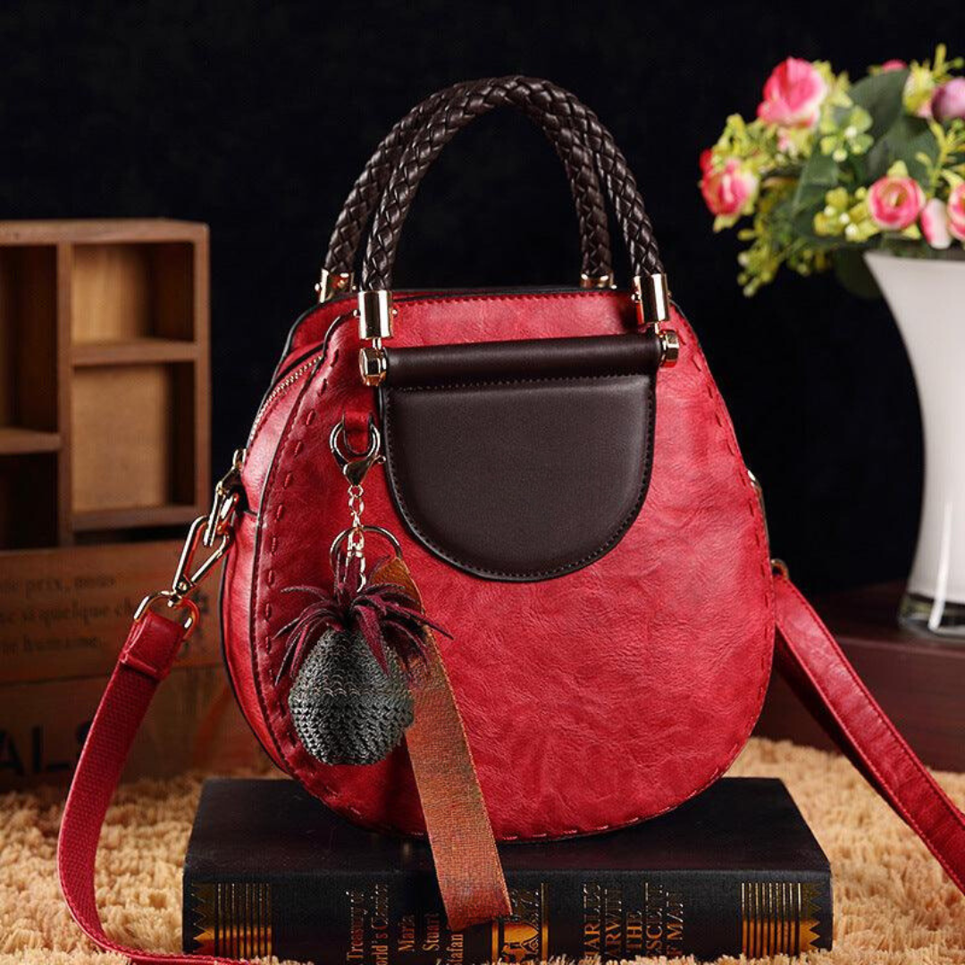 Naelle crossbody bag in burgundy, front view with charm