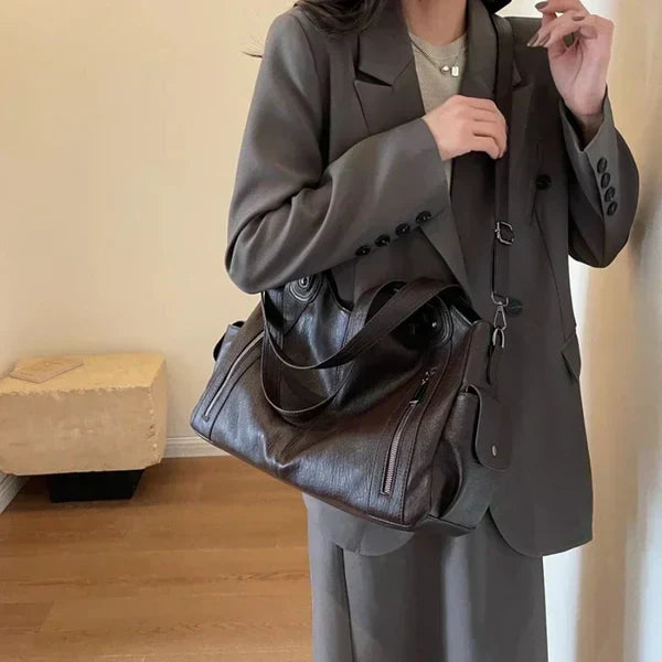 Rae leather handbag in brown styled with a grey suit
