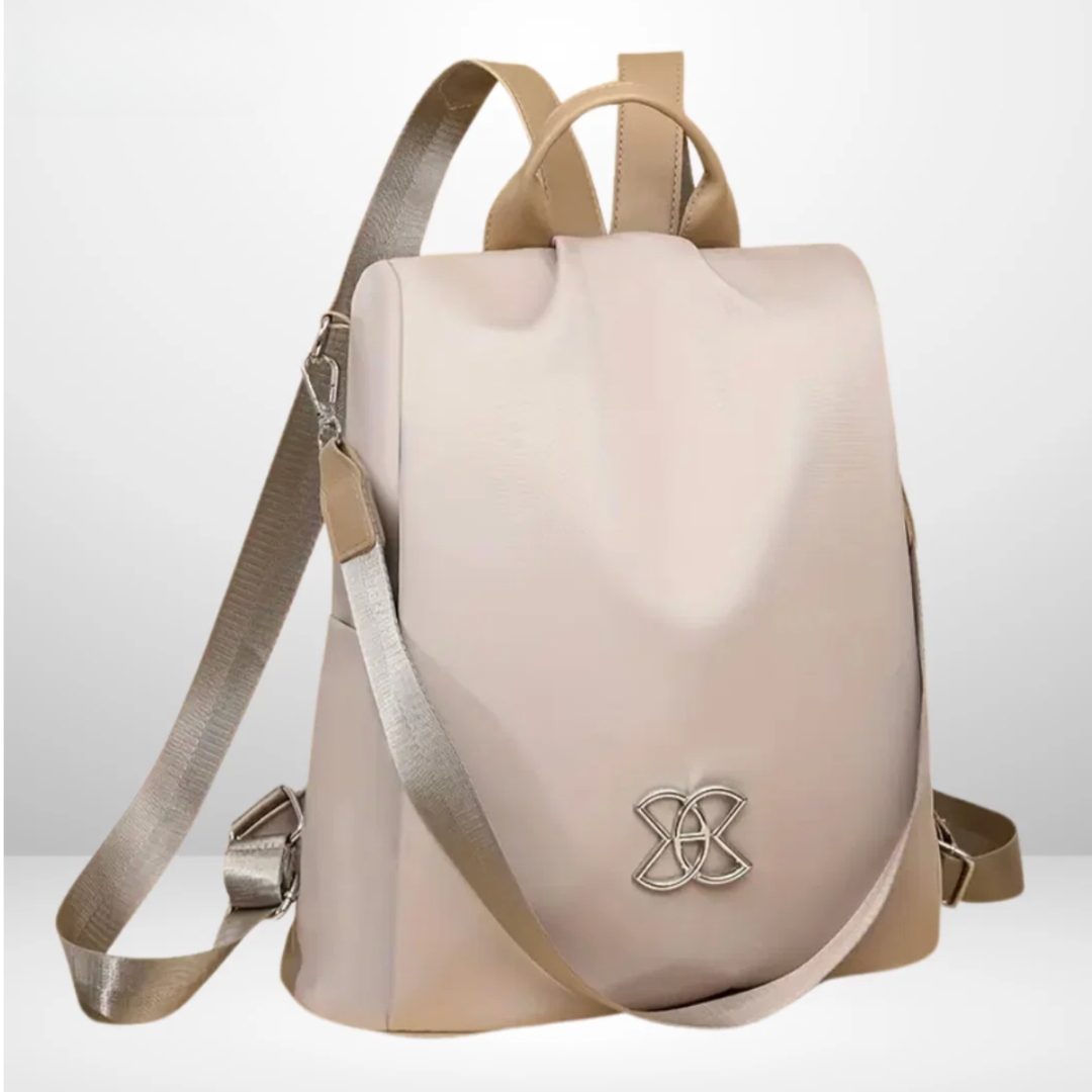 Rosalba anti-theft backpack in beige, front view with silver emblem