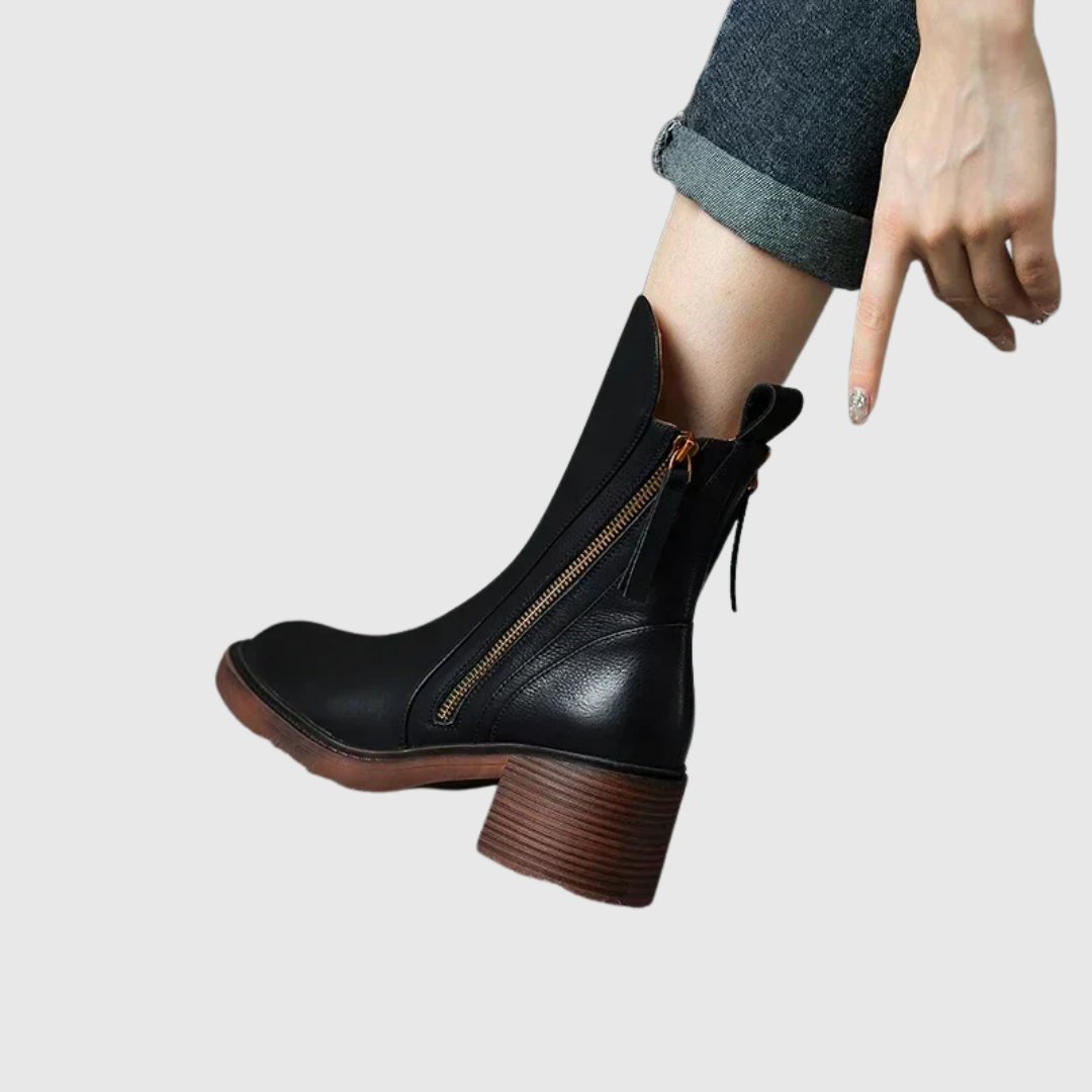 Streamlined ankle boot in black, close-up of zip and stacked heel