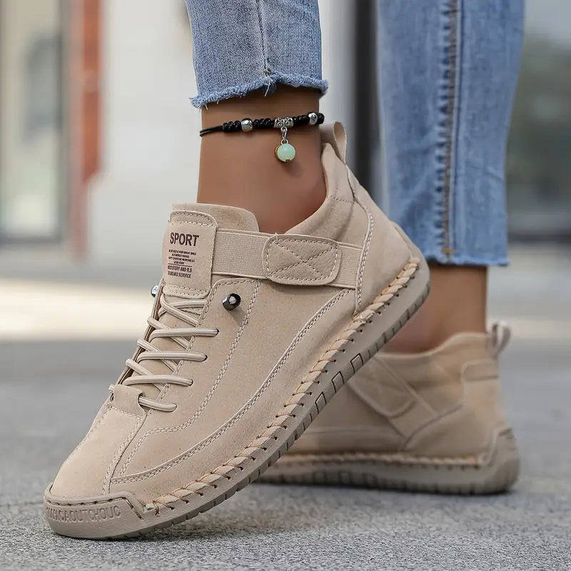 Thessaly supportive sneakers in beige, worn side view on pavement