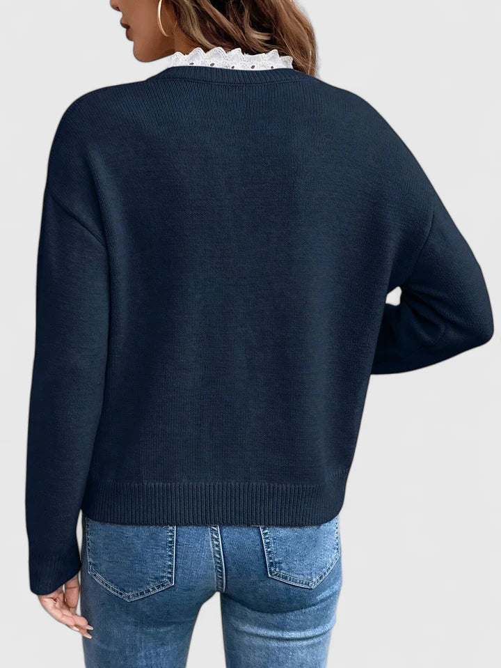 Aven knit sweater in dark blue, back view showing ribbed hem
