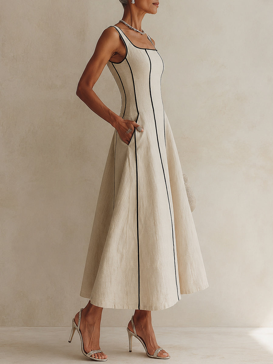 Camille A-line maxi dress in off white, side view with hand in pocket