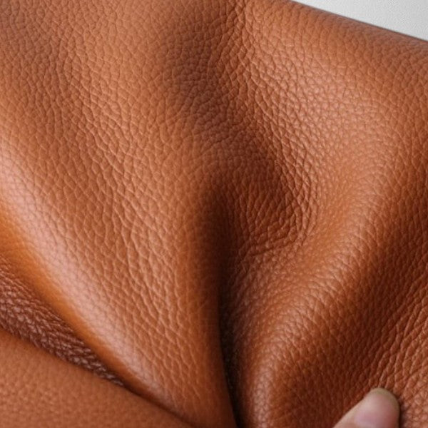 Close-up of pebbled leather grain on the Valérie Dupré bag in brown