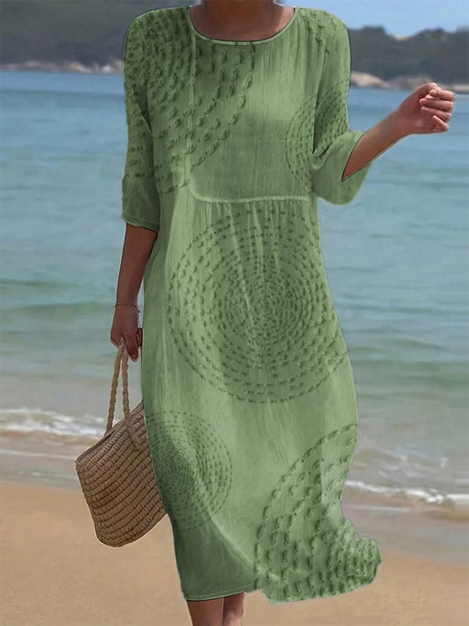 Embroidered casual midi dress in green, full-length front view on the beach