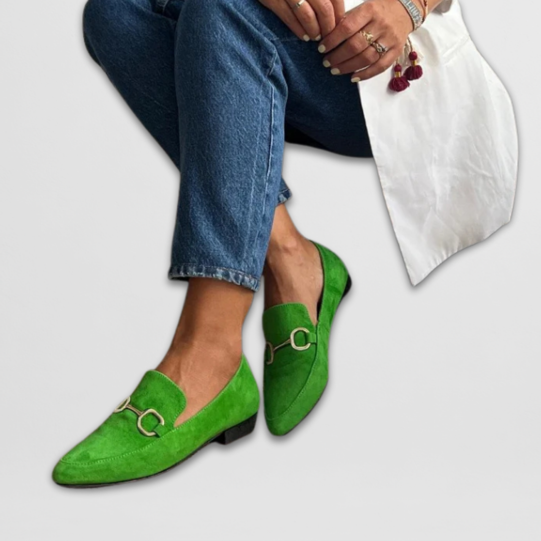 Florence green loafers styled with turned-up jeans, seated side view