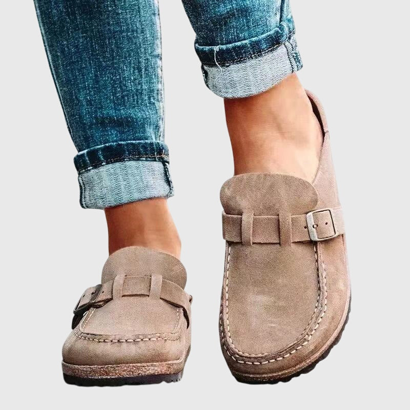Kendra clogs in beige worn with rolled-up jeans, side view