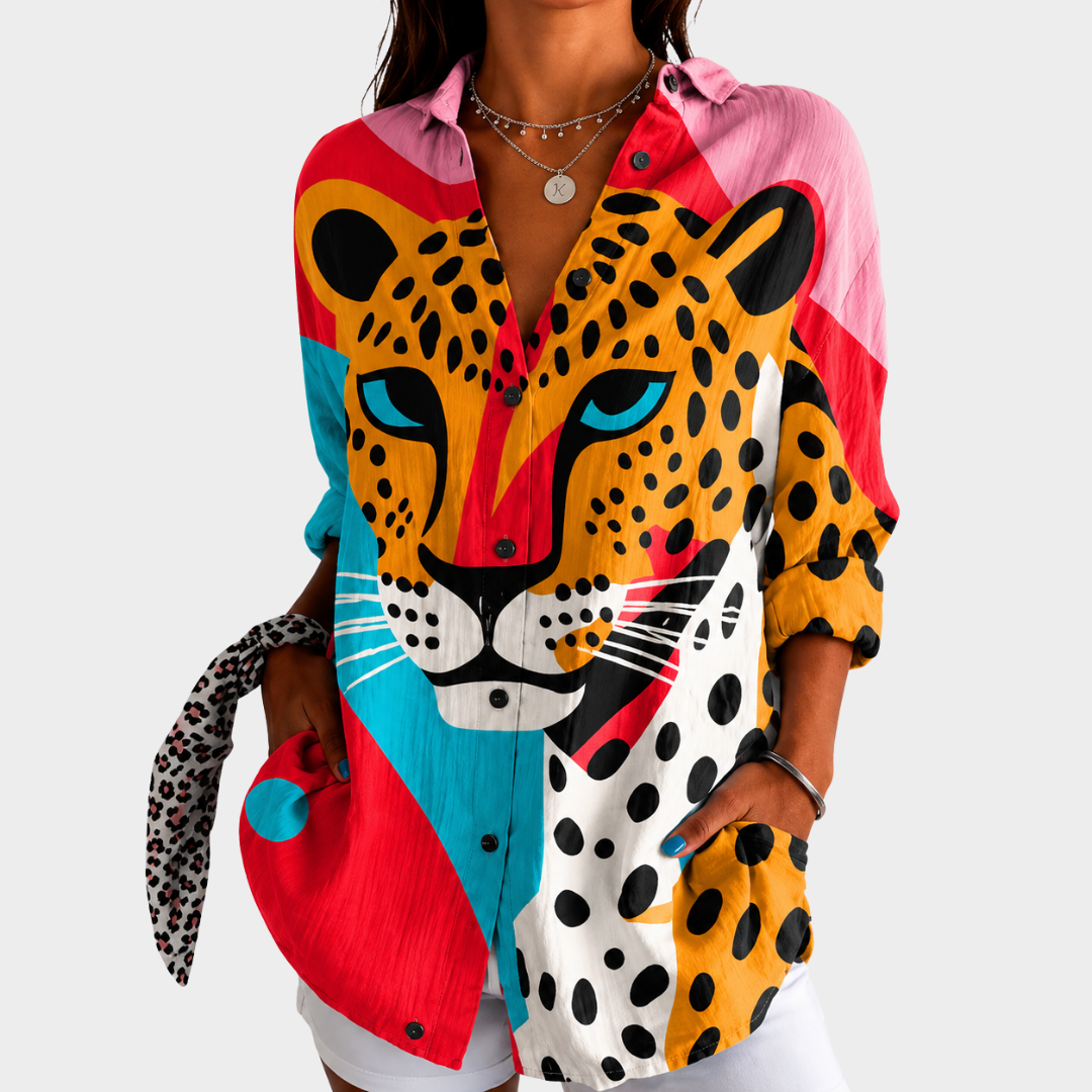 Bold leopard print blouse in multicoloured graphic print, front view worn with white shorts