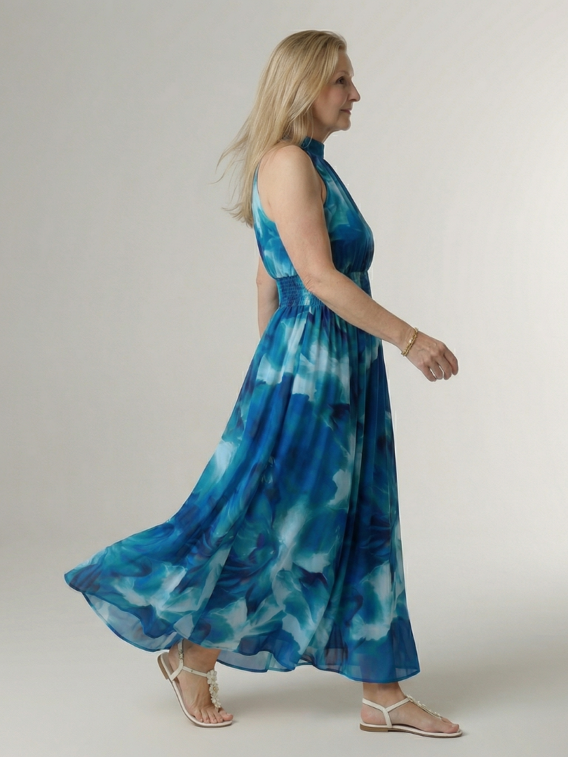 Sylin halter midi dress in blue, side view mid-step