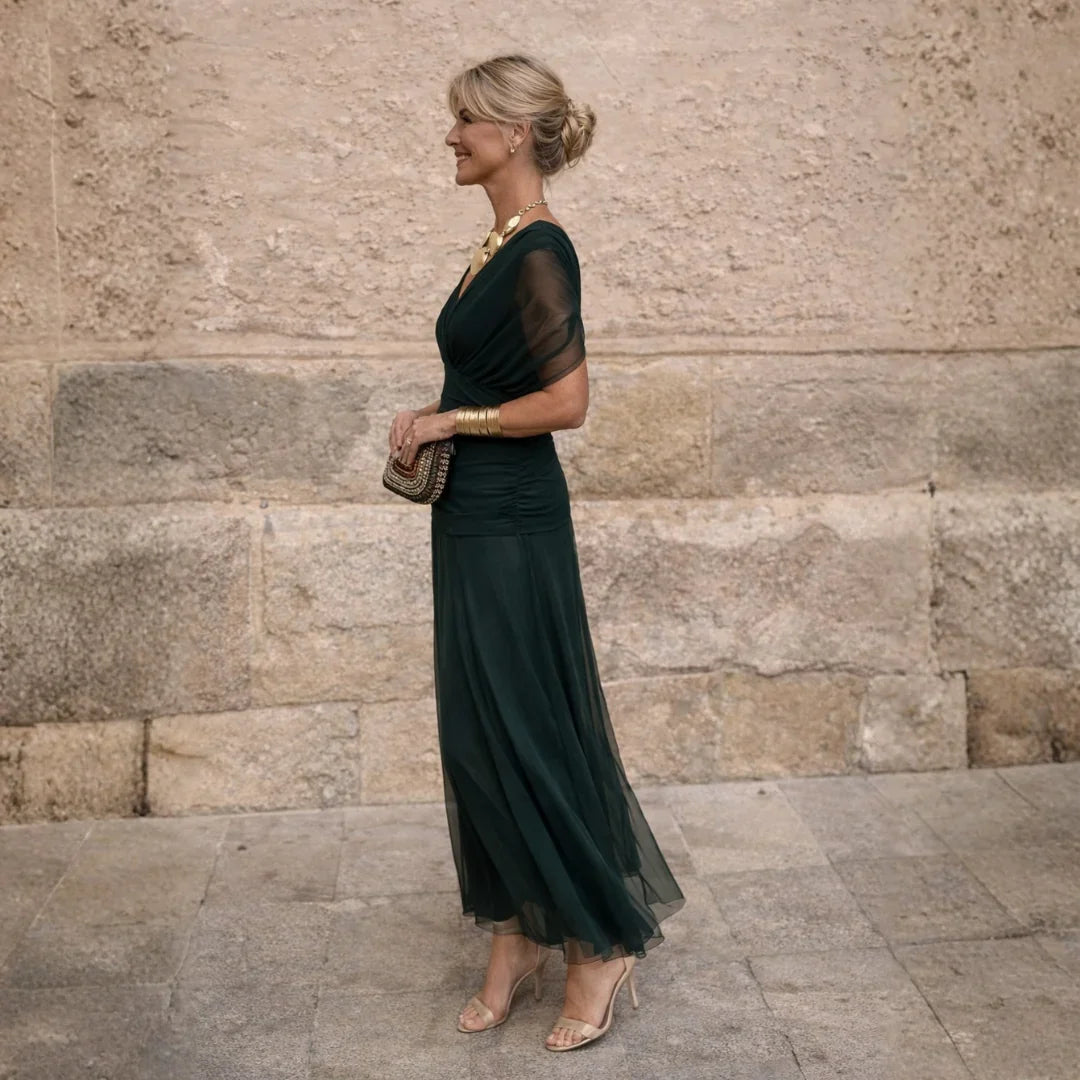 Eliza maxi dress in deep green, side view showing flowing skirt