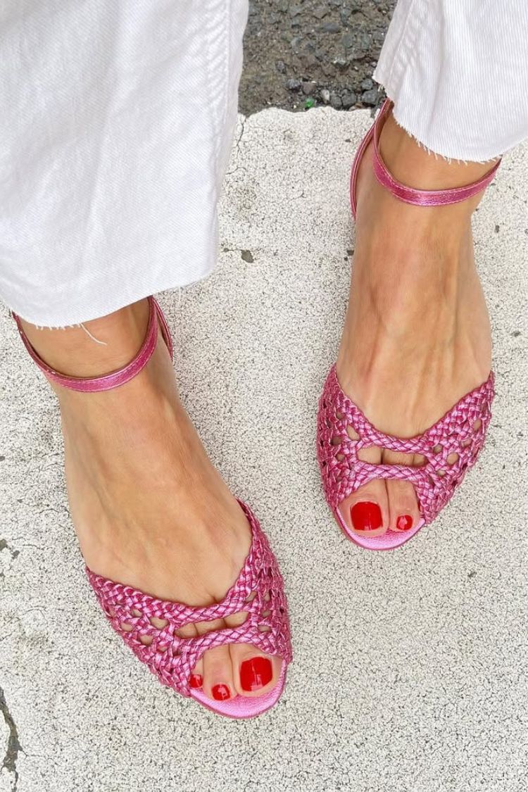 Isadora woven sandals in pink, front view worn with white trousers