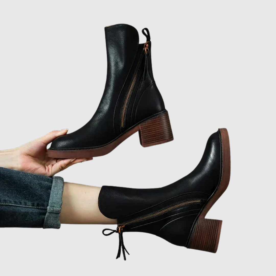 Streamlined ankle boots in black, side view showing front zip and block heel