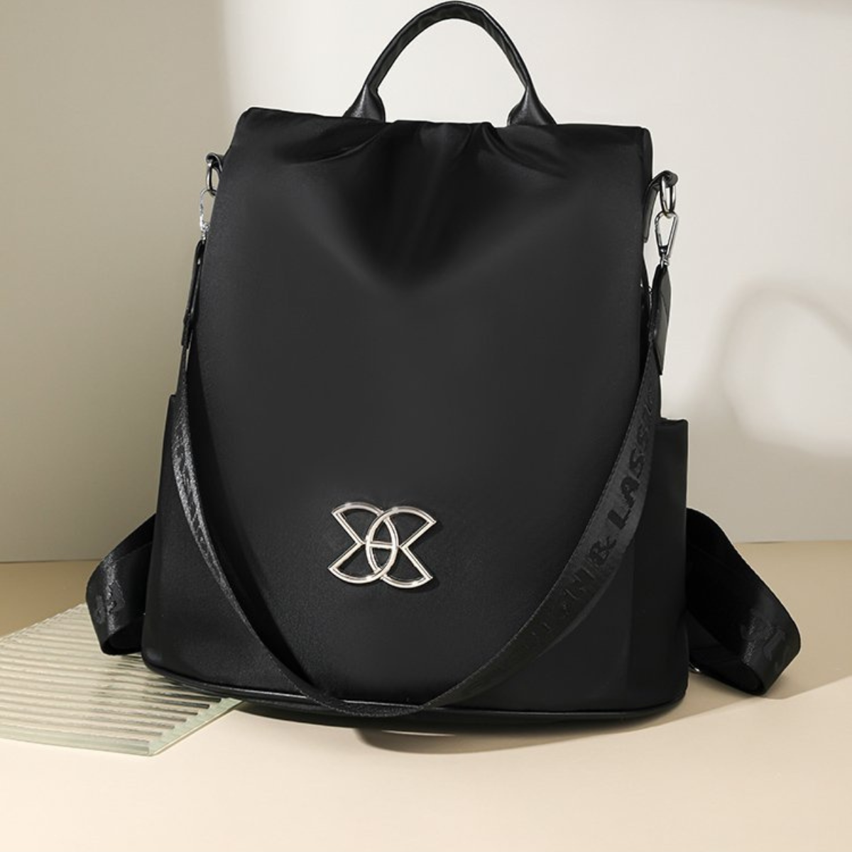 BeBold anti-theft backpack in black with silver emblem, front view