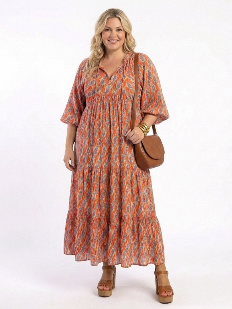 Amara tiered print midi dress worn with wide sleeves, front view