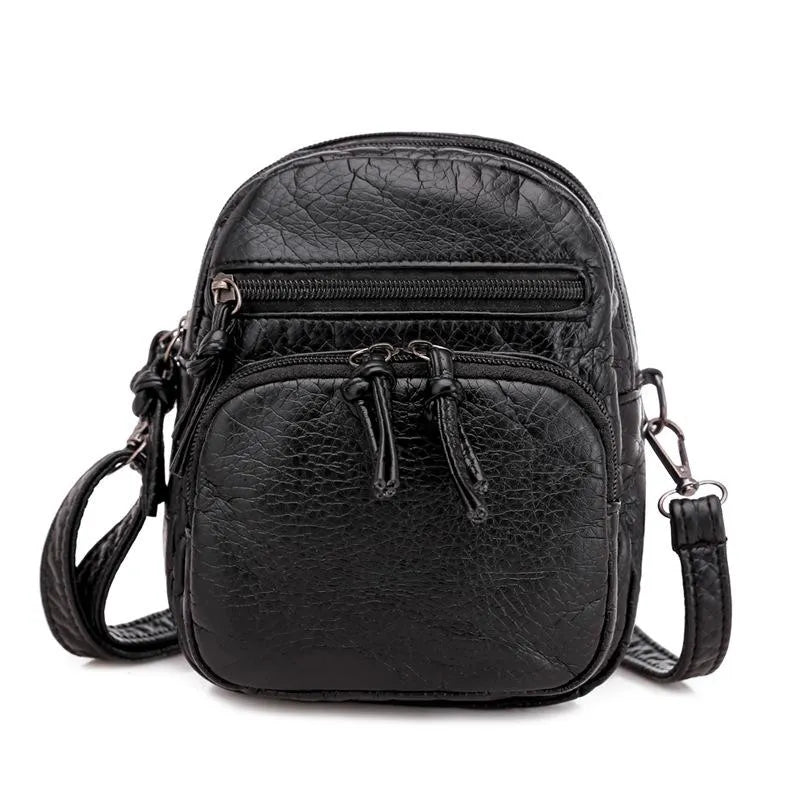 Amira chic satchel in black, front view with shoulder strap