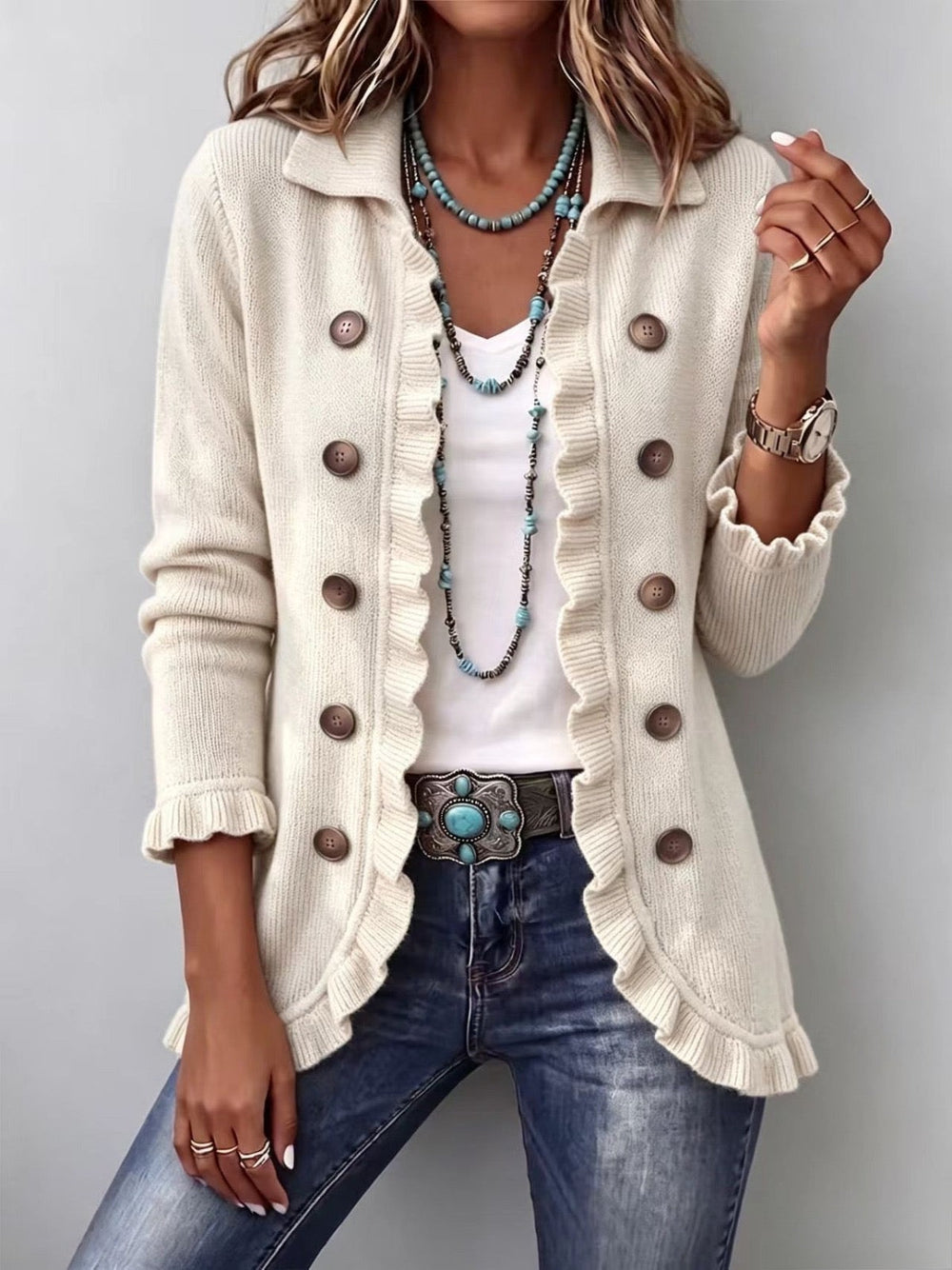 Adelina ivory knit ruffle jacket worn open over a white top with jeans, front view
