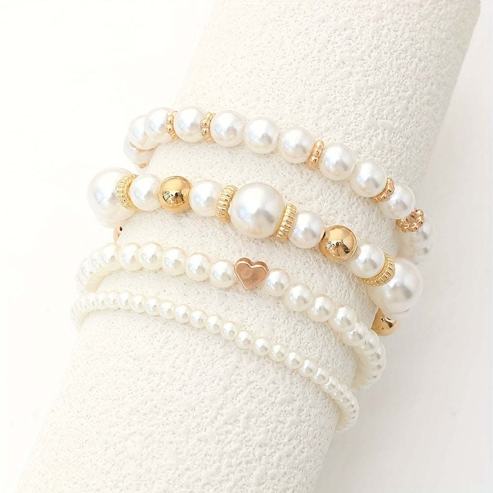 Pearl heart bracelet set in white and gold, four strands shown on display