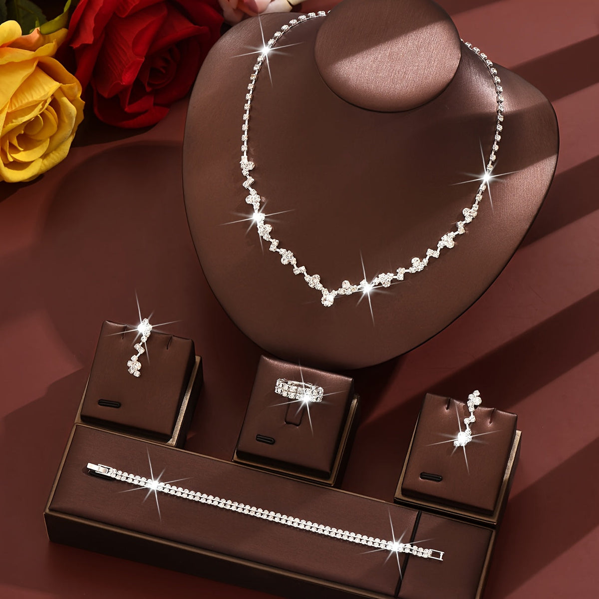 Silver crystal jewellery set displayed on a bust stand with gift boxes