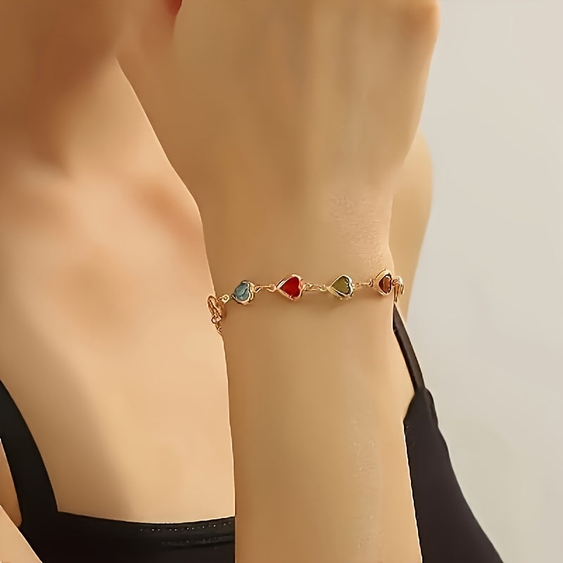 Gold heart-stone bracelet on wrist, side view