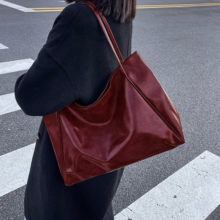 Odessa retro shoulder bag in burgundy, worn side view