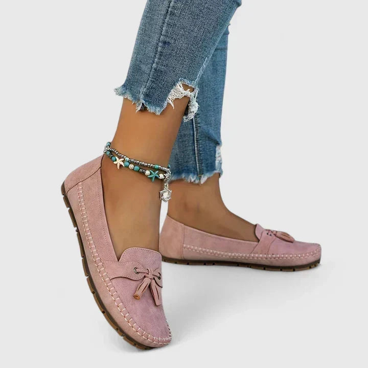 Helena slip-on loafers in pink, worn side view with cropped jeans
