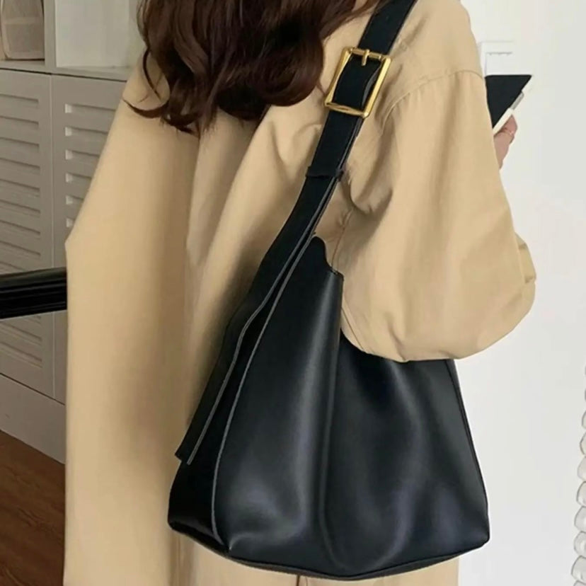 Isolde shoulder bag in black worn over the shoulder