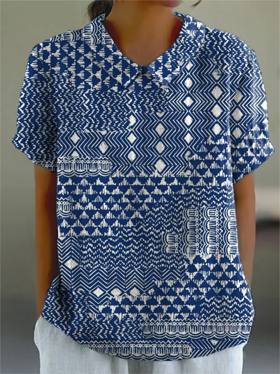 Zara tribal print blouse in blue and white, front view worn with white trousers