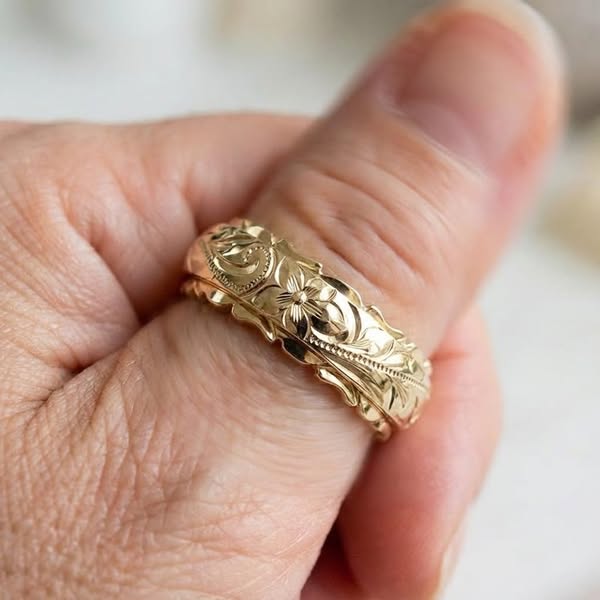 Mila gold floral ring in gold, worn on a finger