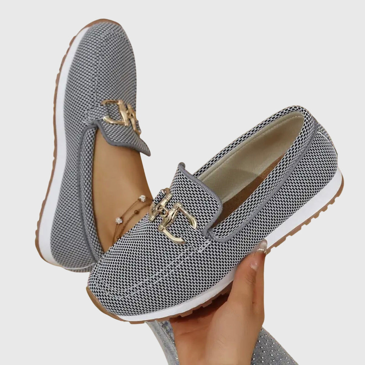 Winifred loafers in grey held in hand, showing sole and insole