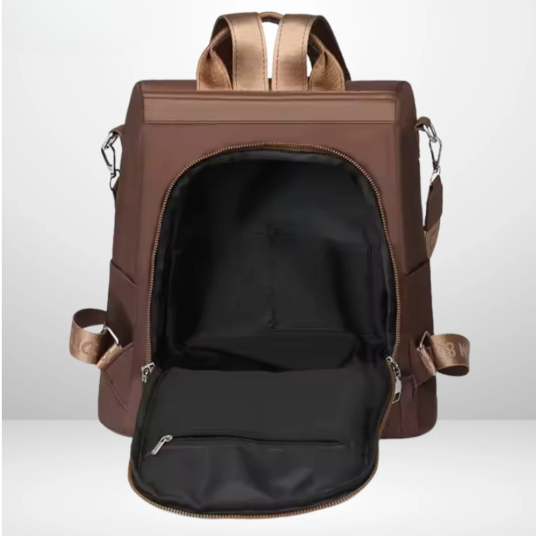 Rosalba anti-theft backpack in brown, open showing lined interior and zipped pocket