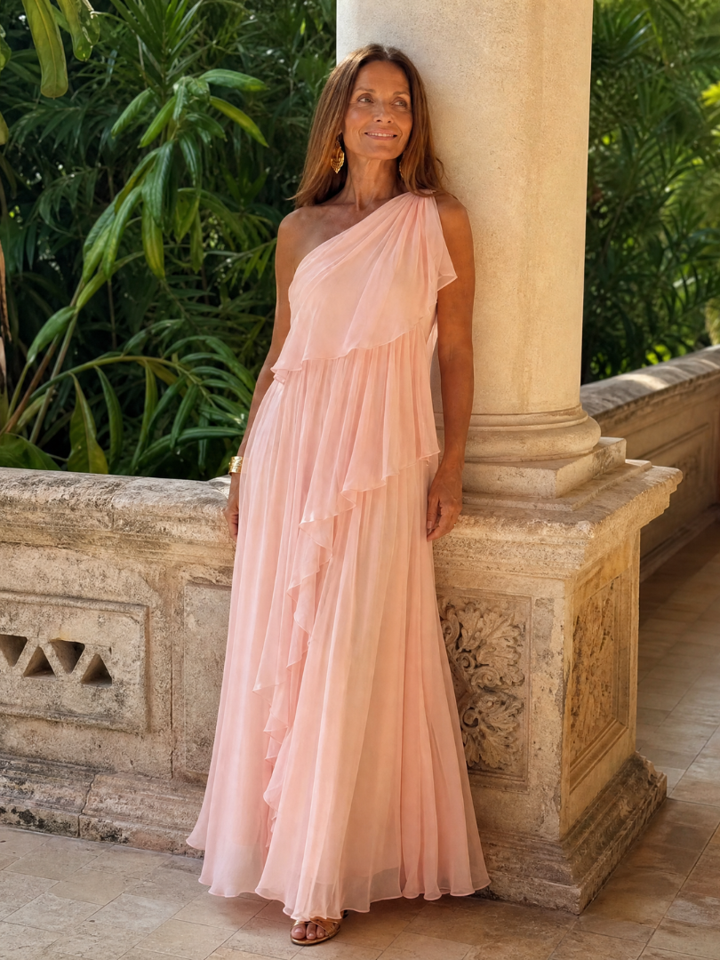 Arabella pink ruffle maxi dress worn beside a stone terrace column