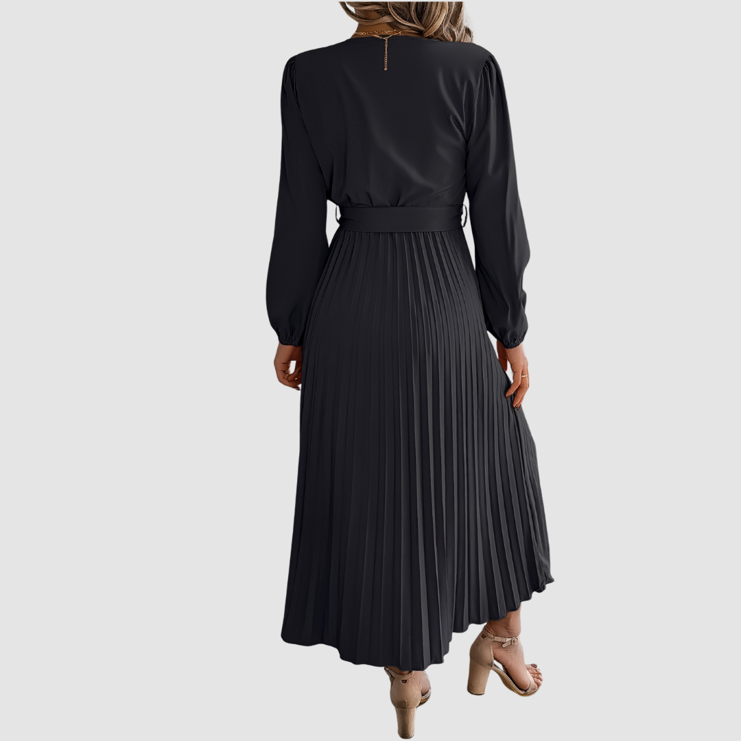 Celeste Bloom pleated midi dress in black, back view of pleated skirt