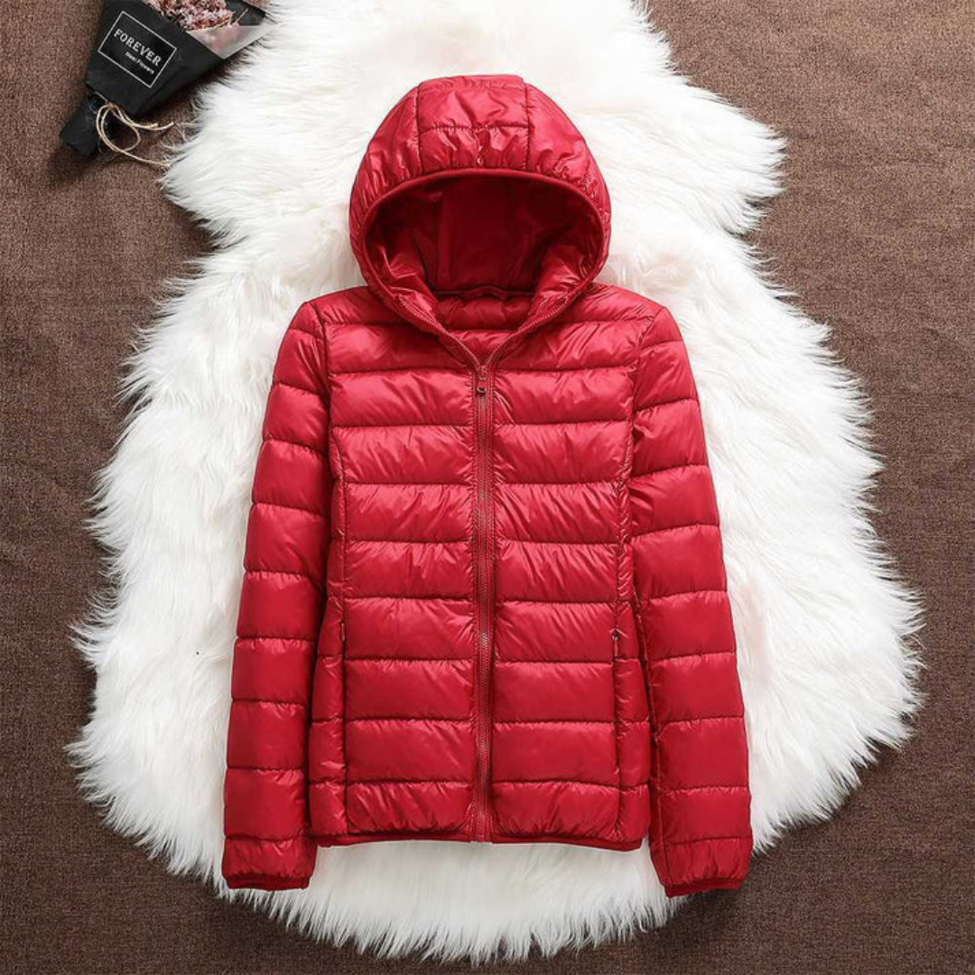 Metta transitional jacket in red, laid flat showing hood and zip