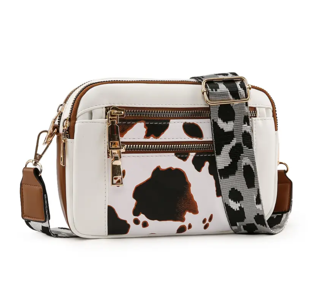 Strap crossbody bag in brown cow print with leopard print strap
