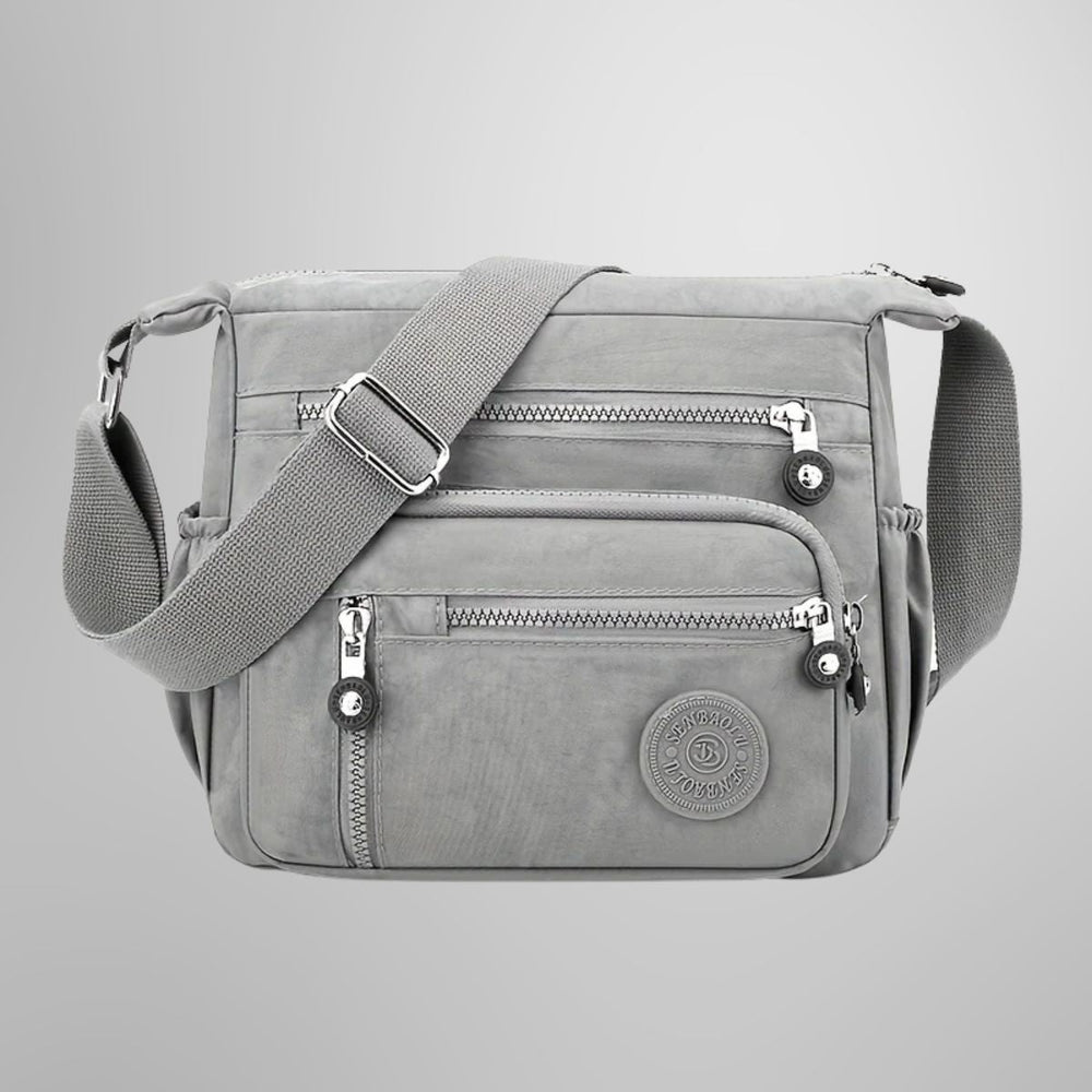 Evelisse modern shoulder bag in grey, front view with zip pockets