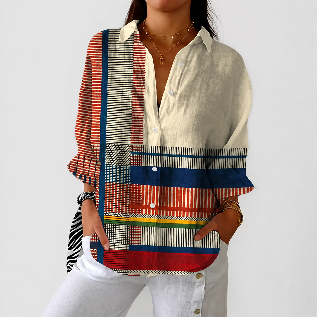 Livia colourful patchwork blouse in multicolour stripes, front view with white trousers