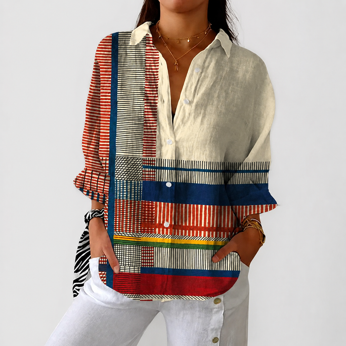 Livia colourful patchwork blouse in multicolour stripes, front view with white trousers